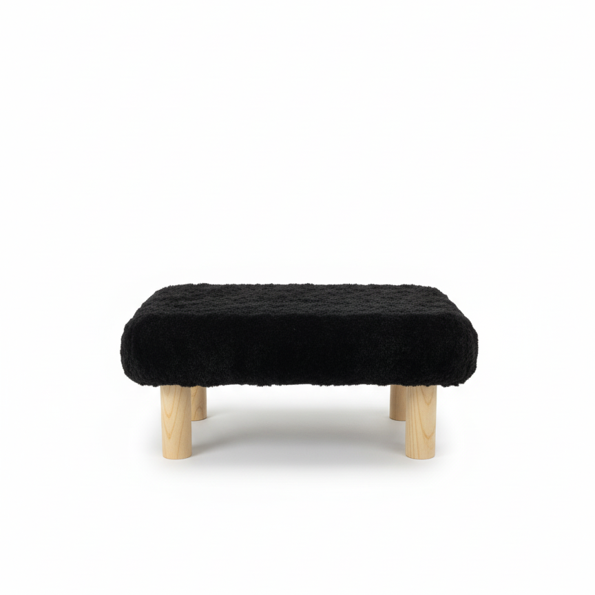 Handcrafted footstool with plush black faux fur top and natural wood legs. On a white background. Made by Little Forest Studio.