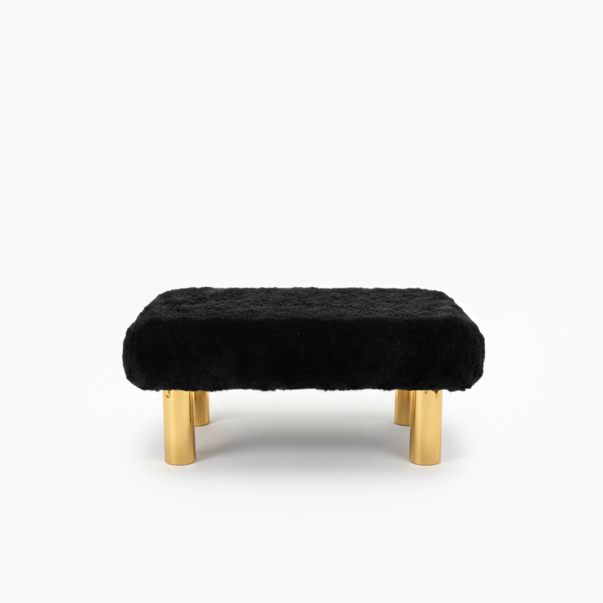 Handcrafted footstool with plush black faux fur top and gold wood legs. On a white background. Made by Little Forest Studio.