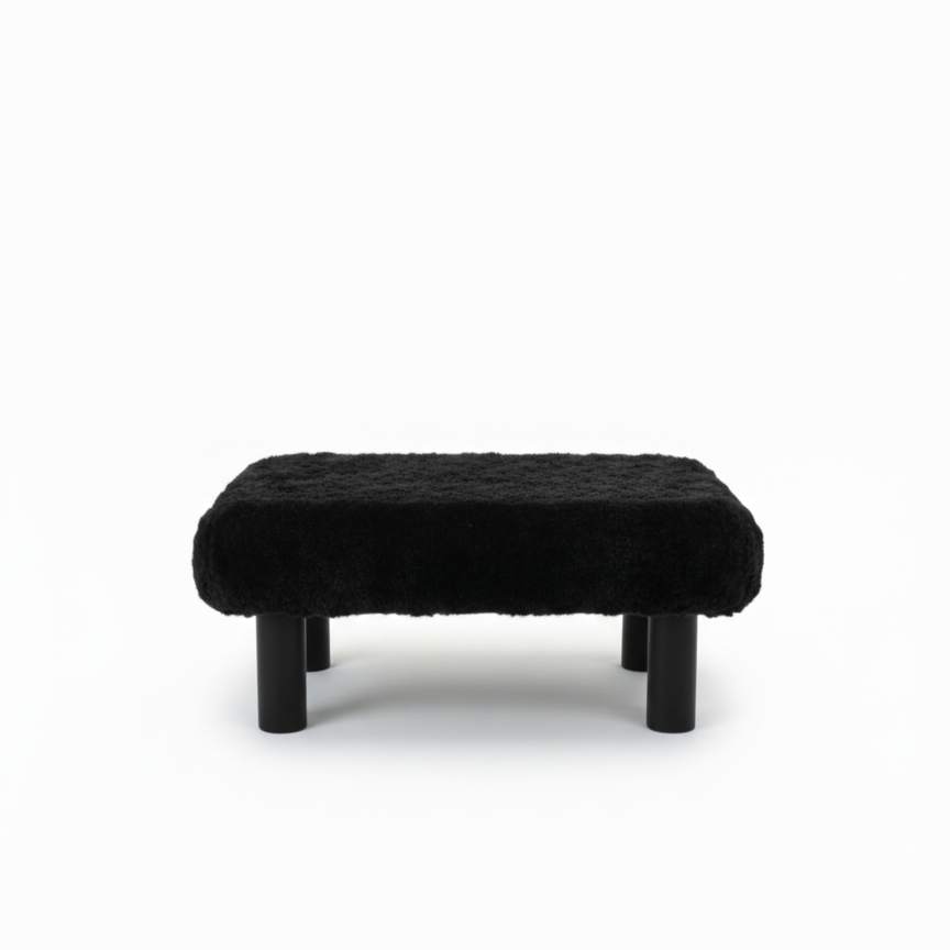 Handcrafted footstool with plush black faux fur top and black wood legs. On a white background. Made by Little Forest Studio.