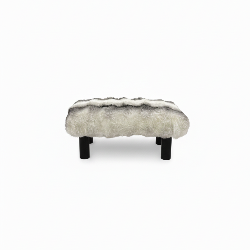 Handcrafted footstool with plush chinchilla print faux fur top and black wood legs. On a white background. Made by Little Forest Studio.