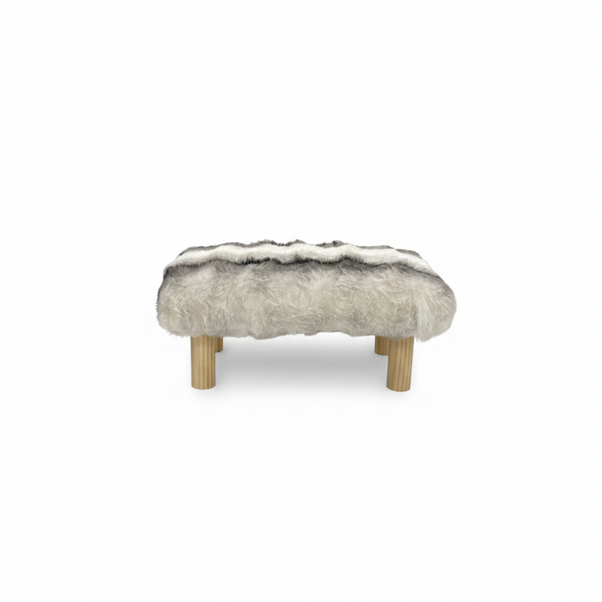 Handcrafted footstool with plush chinchilla print faux fur top and natural wood legs. On a white background. Made by Little Forest Studio.