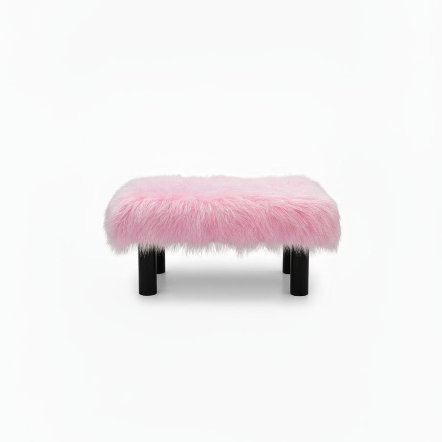 Handcrafted footstool with plush light pink shaggy faux fur top. It has wooden black legs. On a white background. Made by Little Forest Studio