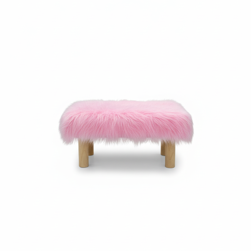 Handcrafted footstool with plush light pink shaggy faux fur top. It has wooden natural legs. On a white background. Made by Little Forest Studio