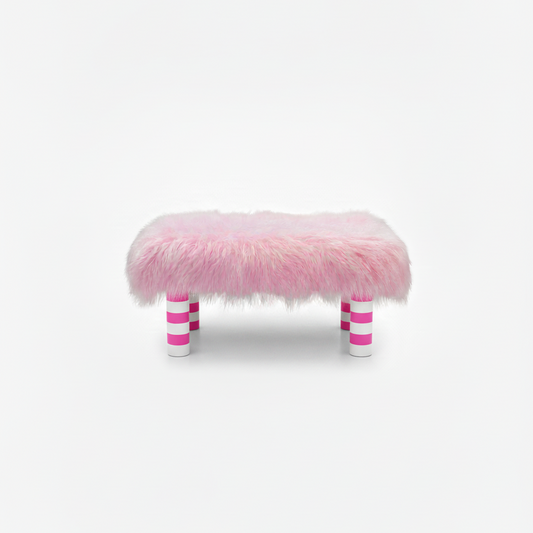 Handcrafted footstool with plush light pink shaggy faux fur top. It has wooden pink and white stripe legs. On a white background. Made by Little Forest Studio.