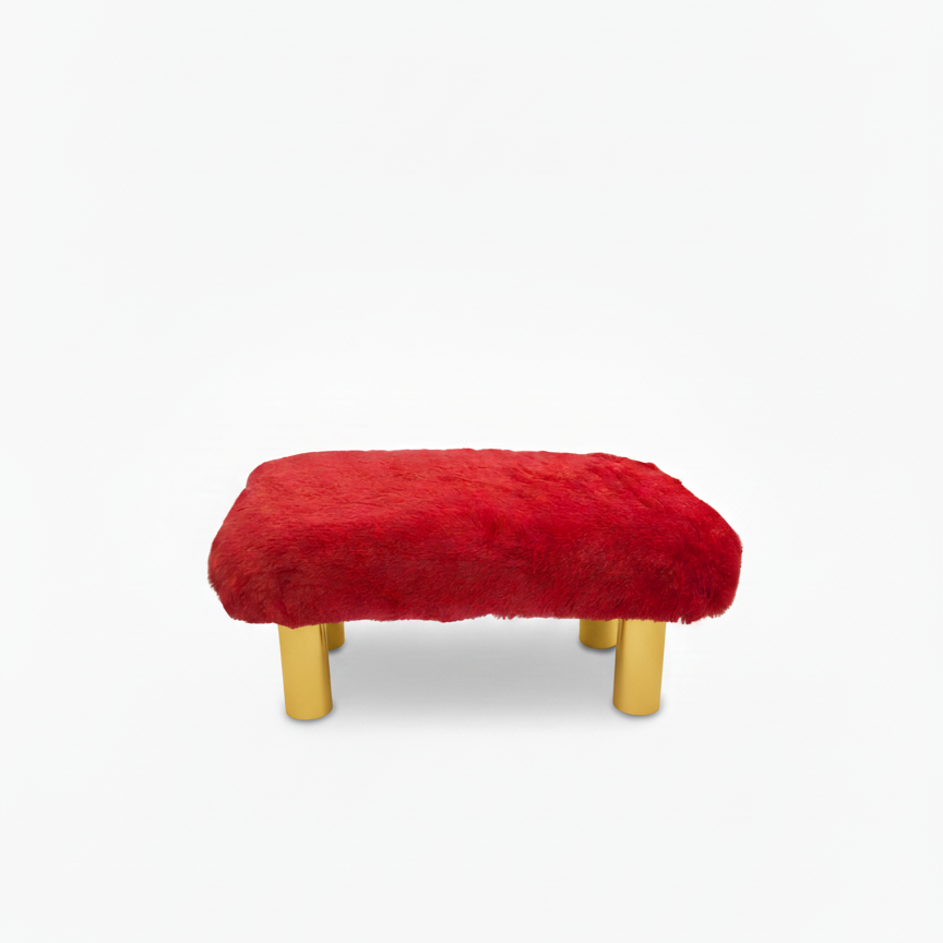Handcrafted footstool with plush red faux fur top. It has gold wood legs. On a white background. Made by Little Forest Studio.