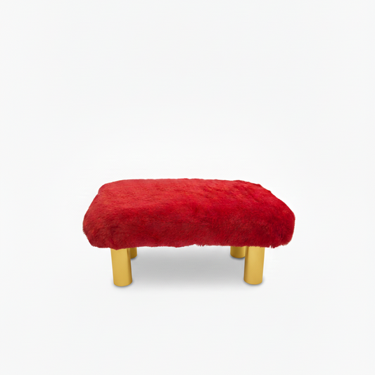 Handcrafted footstool with plush red faux fur top. It has gold wood legs. On a white background. Made by Little Forest Studio.