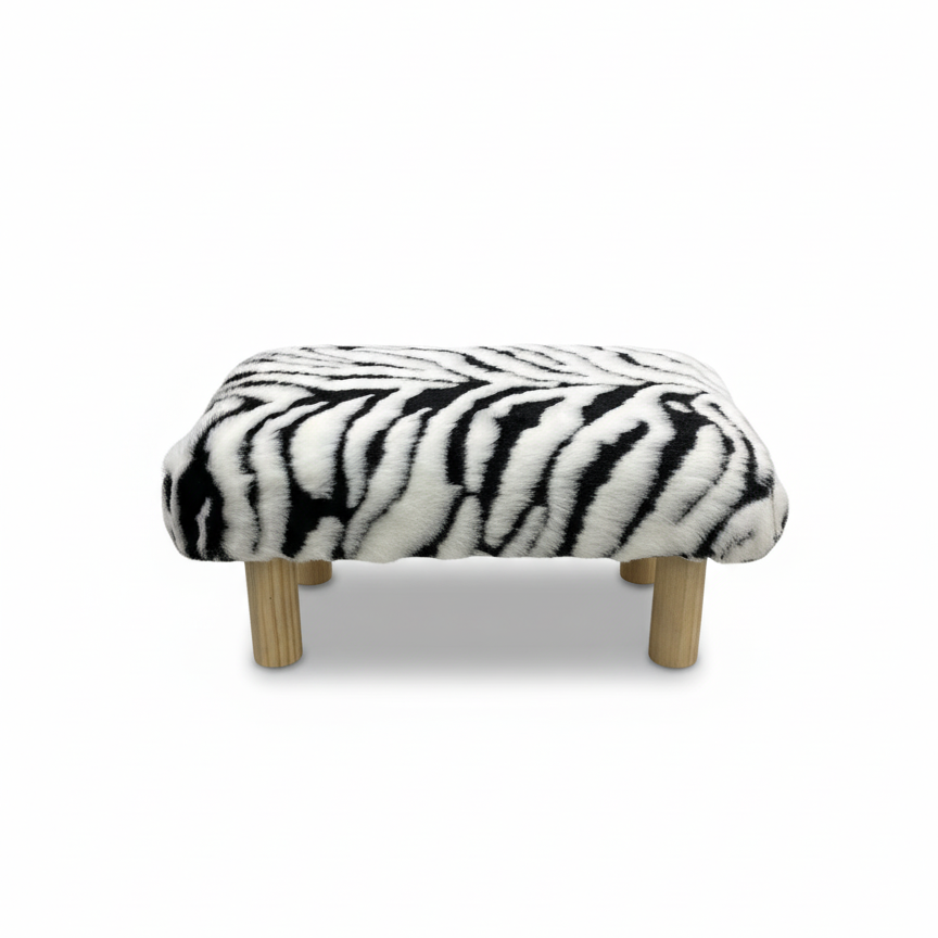 Handcrafted Zebra print faux fur footstool with natural wood legs, made by Little Forest Studio.
