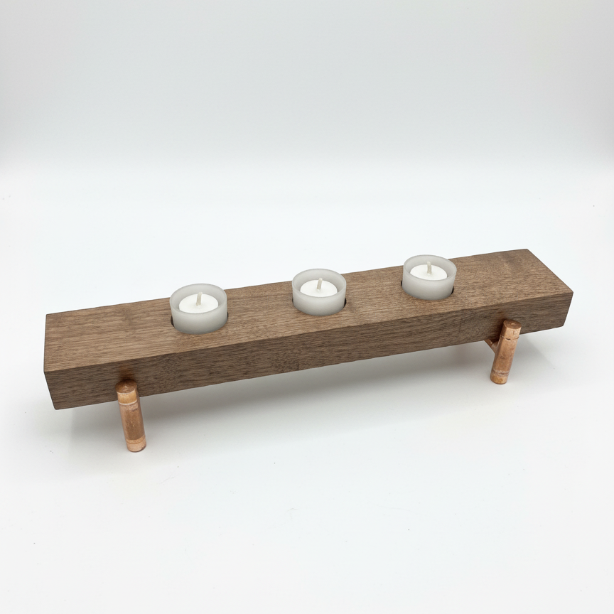 Handmade walnut and copper wooden tea light holder with three frosted glass tea lights on a solid copper pipe base– top angle view