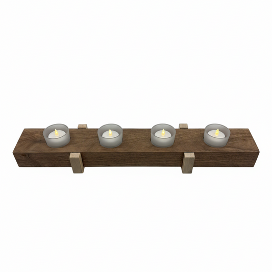 Top view of handmade wooden tea light holder showing walnut base, maple risers, and four frosted glass candles