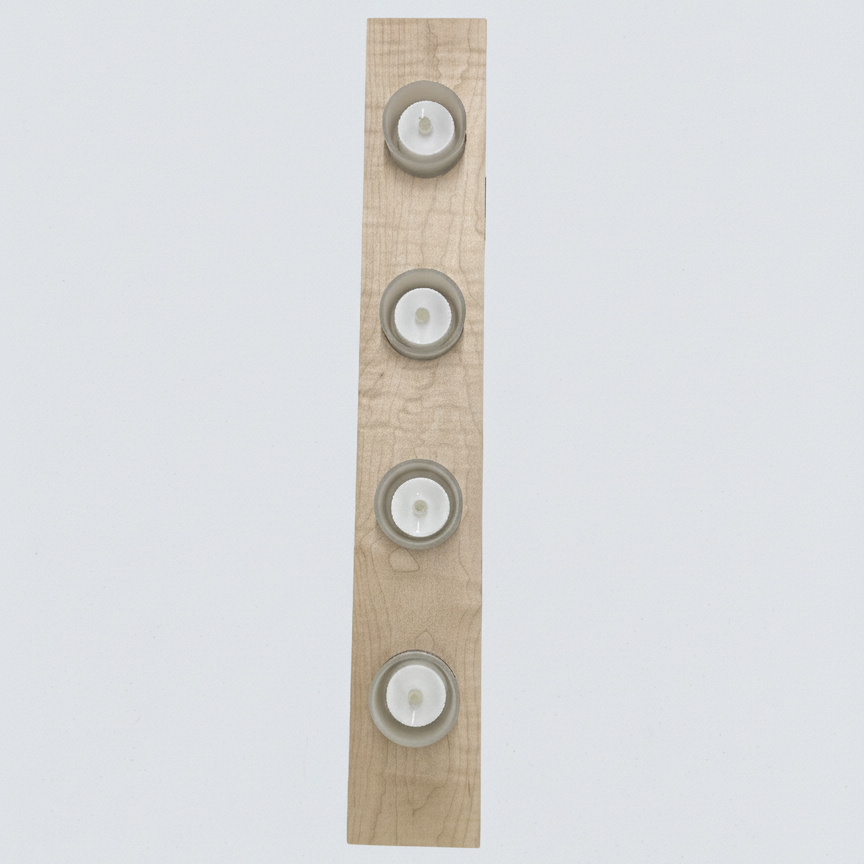Top view of handmade wooden tea light holder showing the quilted maple grain pattern. 